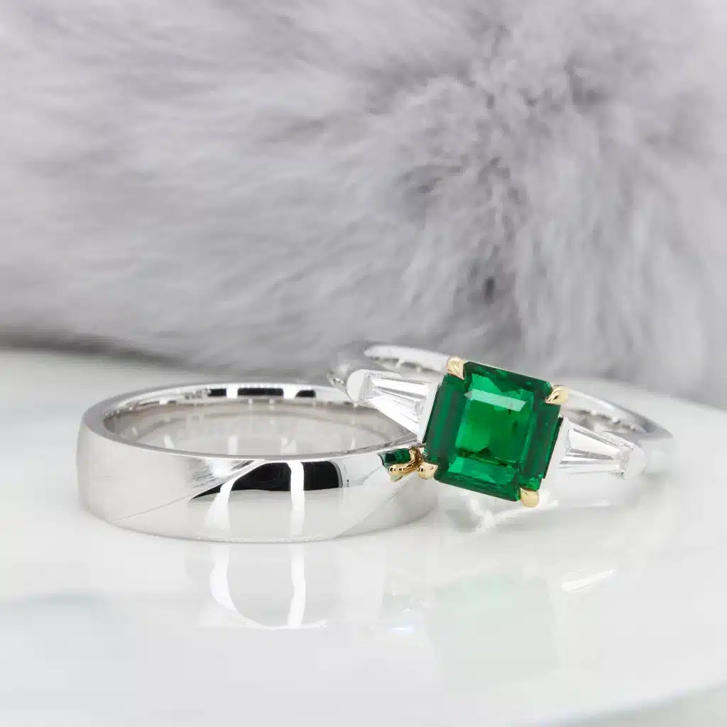 Emerald Engagement Ring with side tapered baguette Diamond fine jewellery design.