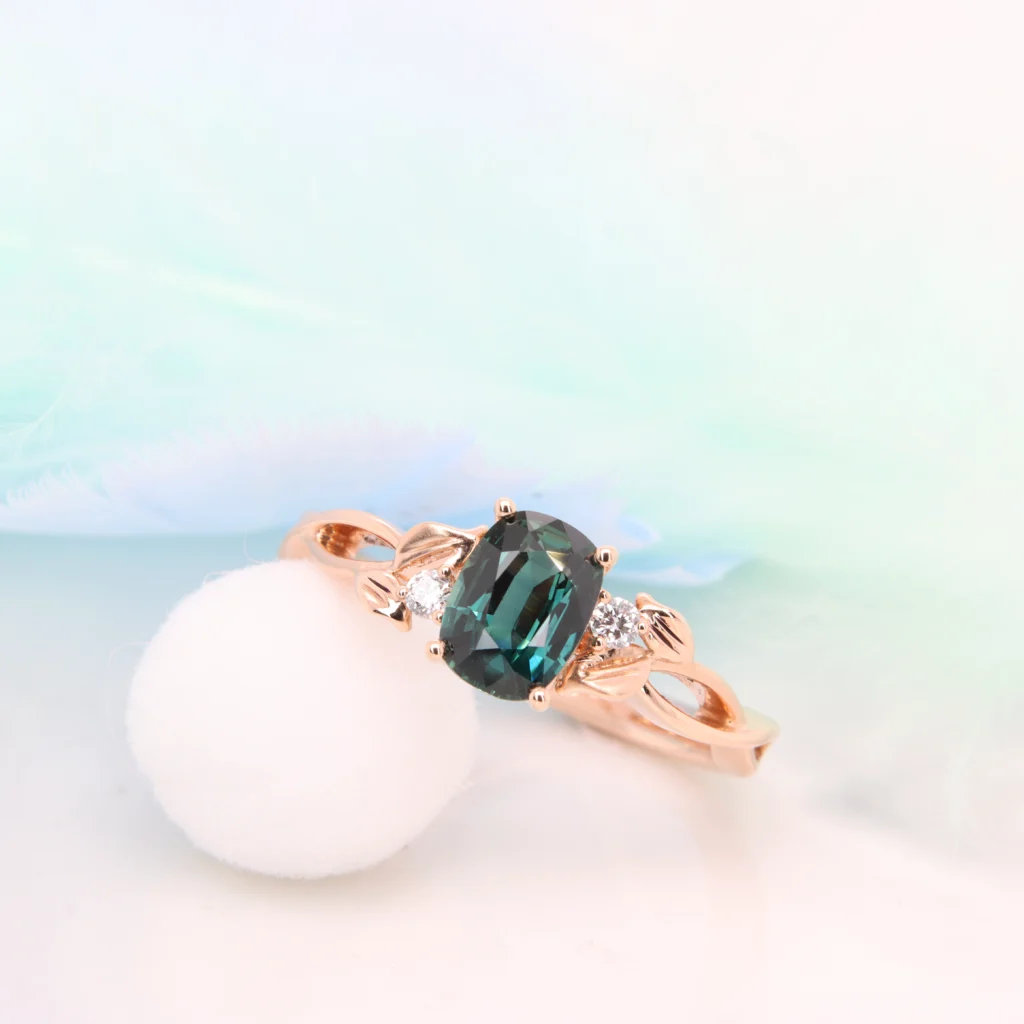 Teal Sapphire wedding ring with floral inspired design. Custom designed with side round brilliance diamond proposal ring