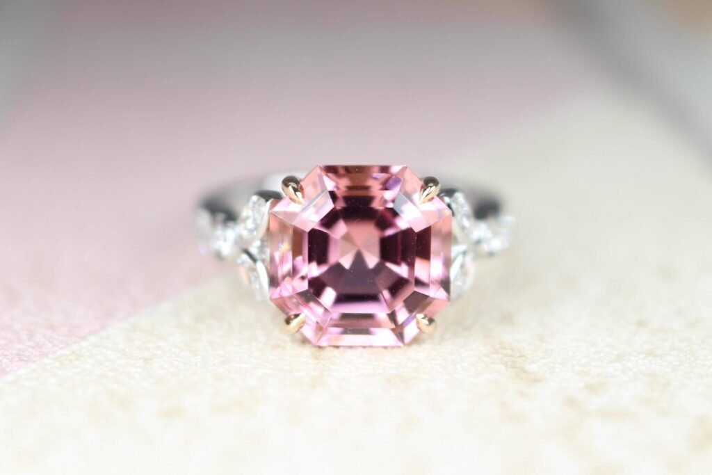 Asscher-cut pink tourmaline ring in a rose gold prong setting with diamond leaf shoulders, an Art Deco design, GIOIA Singapore