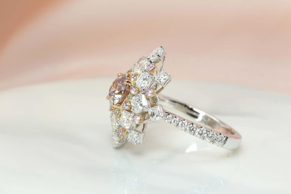 Pink Diamond, truly exquisite in design, quality and colour. Featuring a pink-hued diamond surrounded with sparkling diamonds is a fantastic expression of feminine chick. Local Singapore Jeweller in Customised Fine Jewelry with diamond and coloured gemstone.