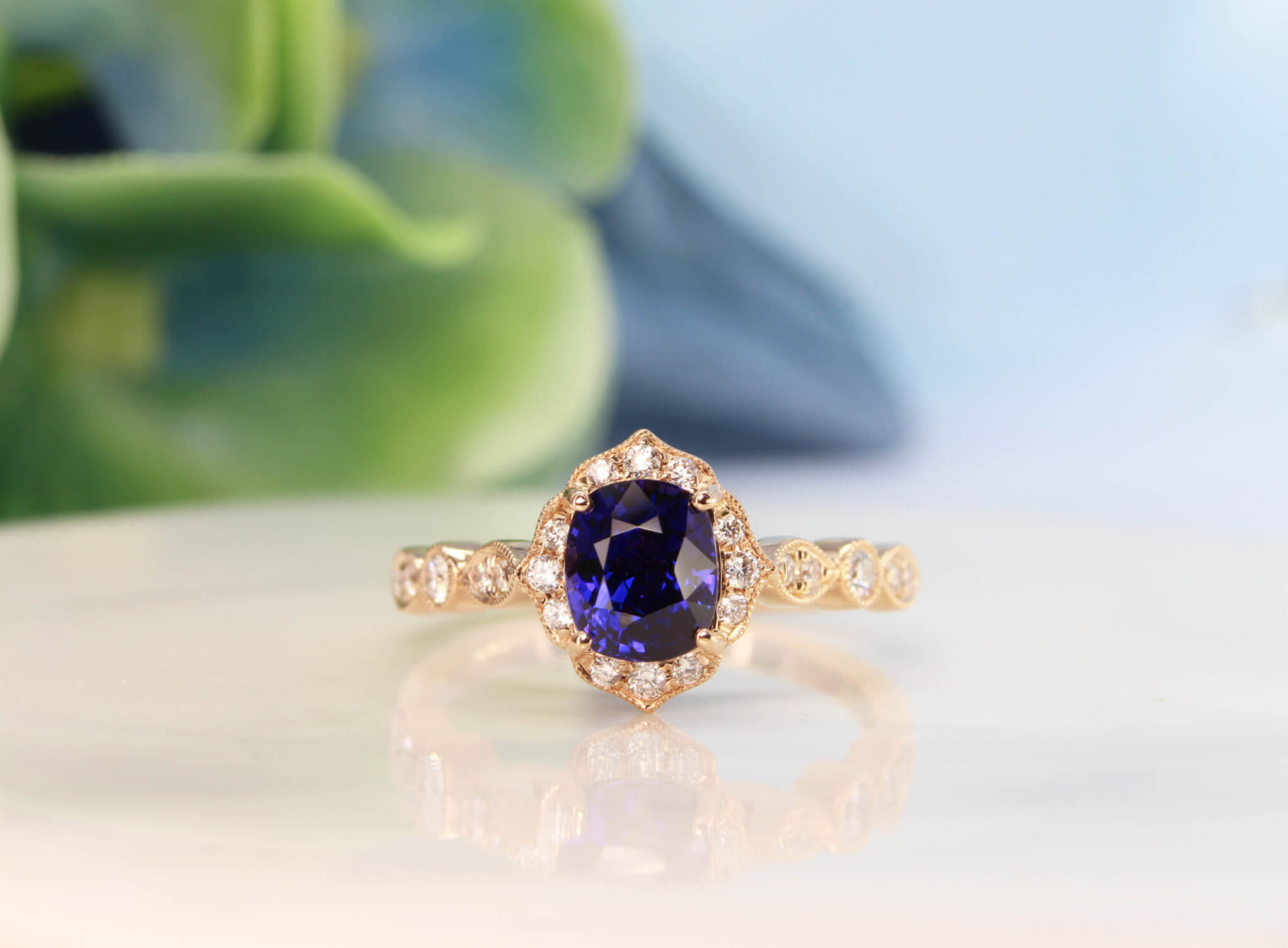 Art deco Proposal Ring with colour change sapphire, surrounded with diamonds to impart a floral and feminine look to this design. This design exudes an overall vintage art deco look with its mil-grain design | Local Singapore Private Jeweller in customised proposal ring.