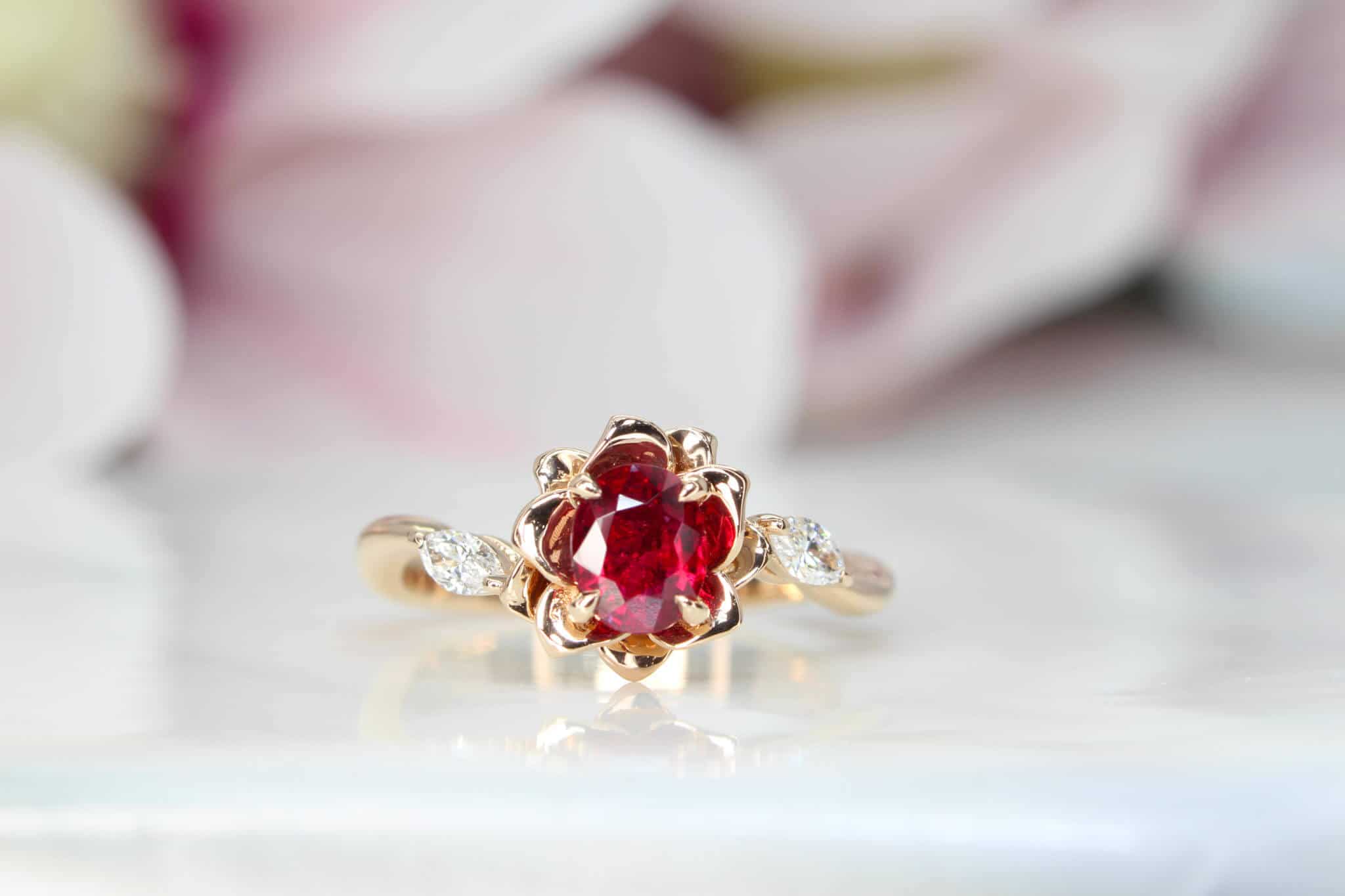Engagement ring features an unheat vivid red ruby rare gemstone. With a liking for flora design, we customised this engagement ring with marquise diamond with flora leaves and petals in rose gold surrounding the ruby gemstone | Local Singapore Jeweller in engagement ring and wedding jewellery.