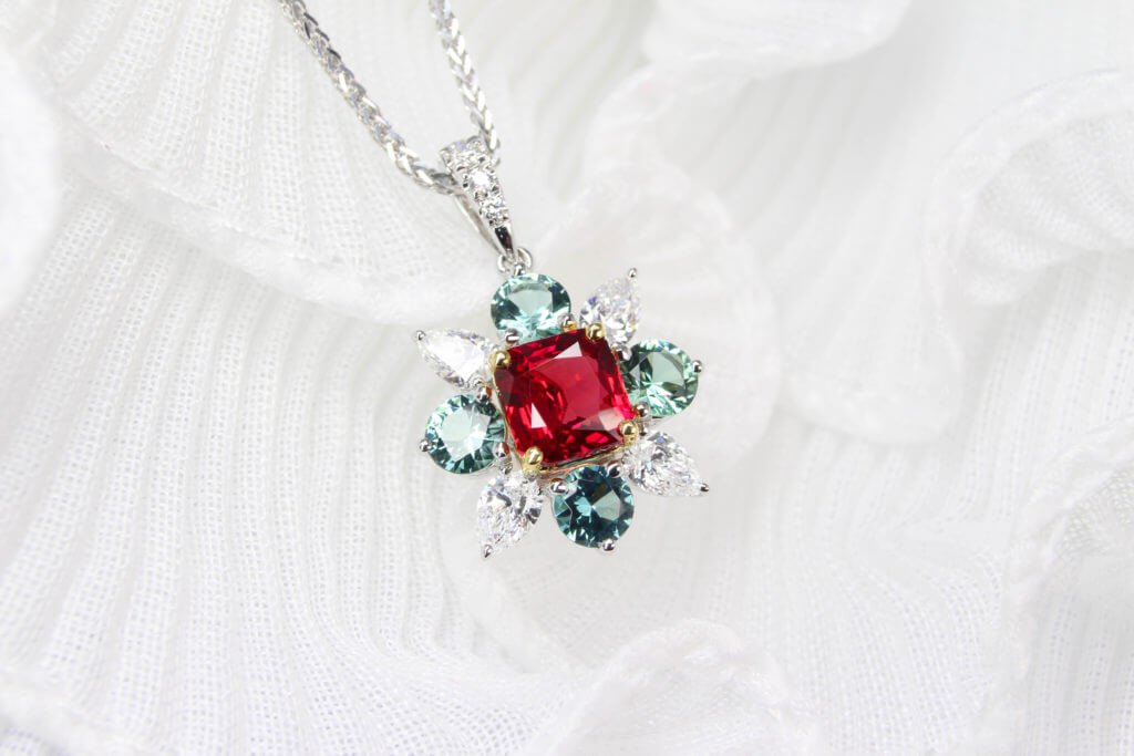 40th anniversary ruby starburst pendant with mint green tourmaline and pear diamonds in yellow gold