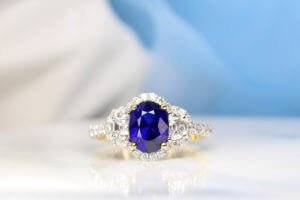 Royal Blue Sapphire with halfmoon and halo diamond ring