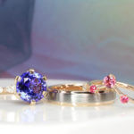 Tanzanite Wedding Rings customised with round brilliance tanzanite in six prongs ring setting with marquise and round diamonds on side bands - Proposal & Wedding Bands customised to complement the proposal ring | Local Singapore Jeweller in customised jewellery with Tanzanite and coloured gemstone