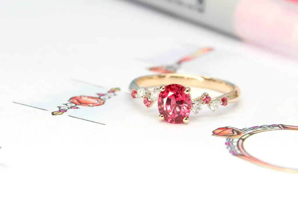 Customised engagement ring featuring a vivid pinkish-red spinel and round brilliant diamonds - GIOIA Fine Jewellery Singapore.