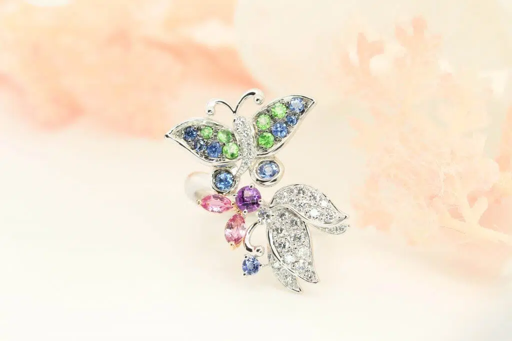 Gemstone Customised ring bearing a butterfly theme symbolises feminism and the inherent beauty of the person. Butterflies symbolise transformation in life and are believed to bring serenity and happiness to life. The fine detailing and delicate design make this natural inspired design fine jewellery with coloured gemstone special and one of a kind.