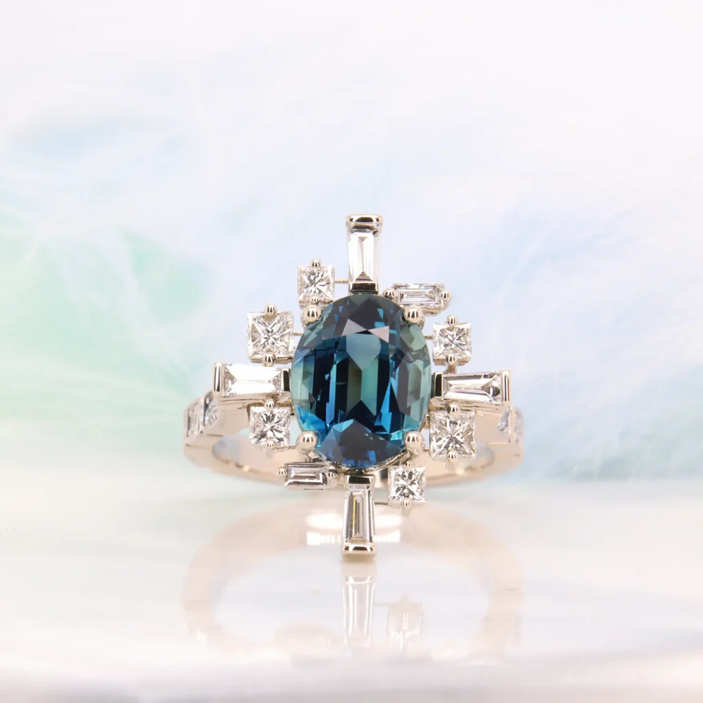Oval blue sapphire Art Deco ring with a baguette and square diamond halo in champagne gold