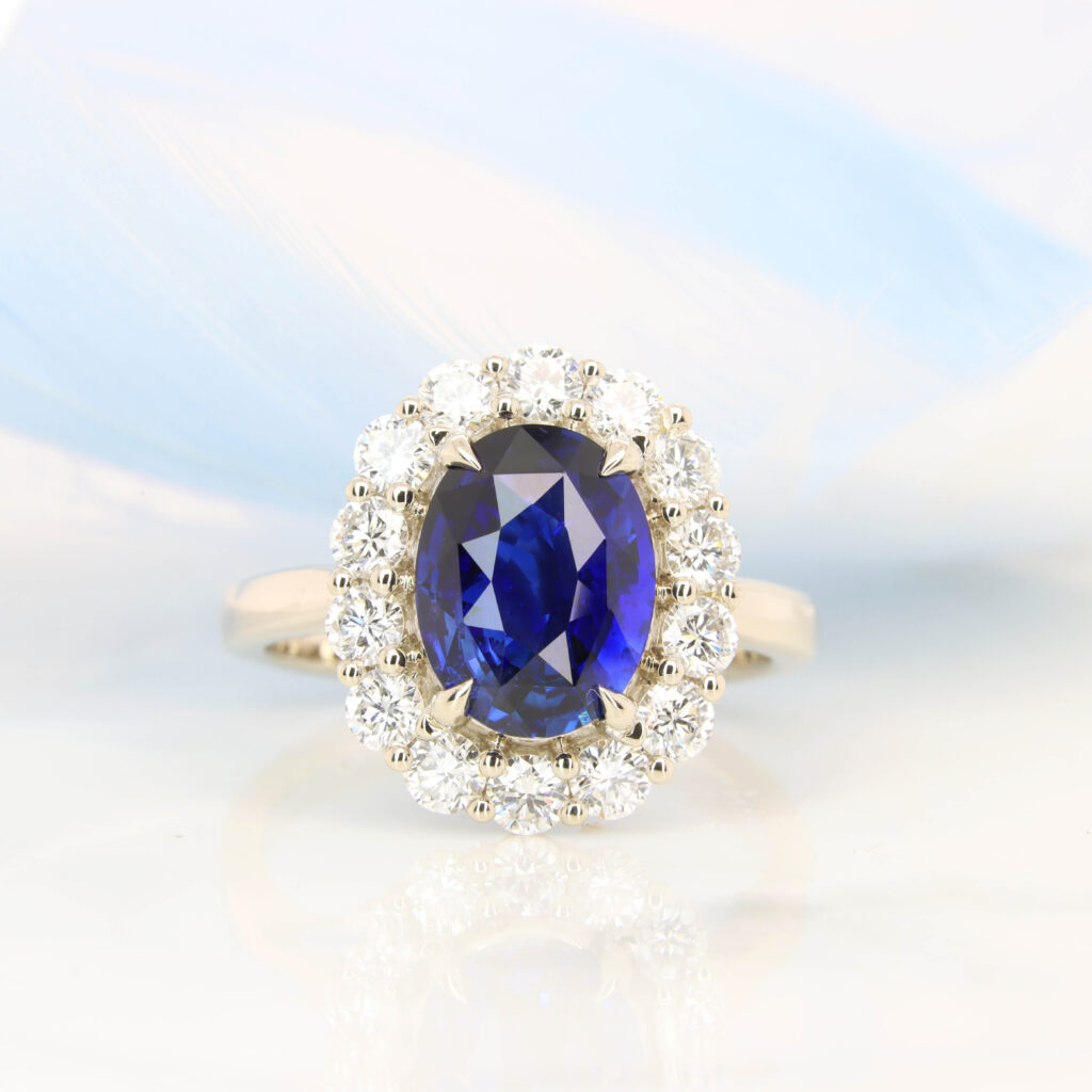 Royal Blue Sapphire Engagement Ring vivid blue with surrounding halo diamond ring.
