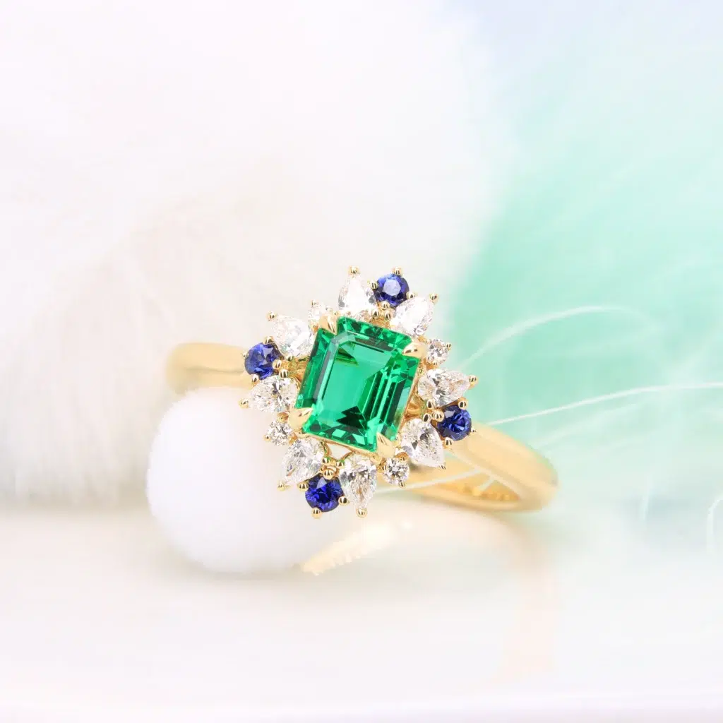 Emerald Proposal Ring with Halo Diamond Ring with diamond and blue sapphire in Singapore by GIOIA Fine Jewellery
