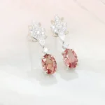 Padparadscha sapphire earrings, a pair of unheated 1.05ct and 1.12ct oval sunset pink-orange sapphires GRS certified, lotus diamond design in champagne and white gold, GIOIA bespoke commission Singapore