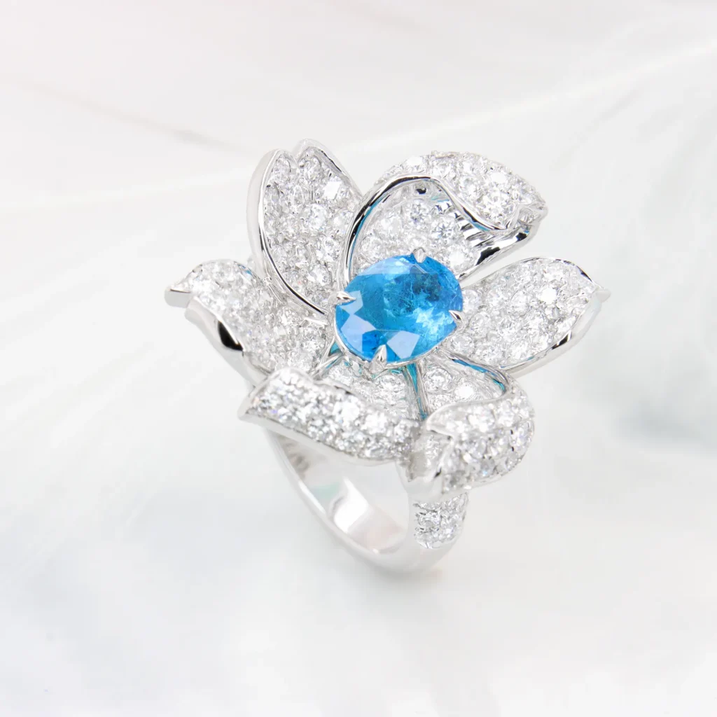 Side view of the Paraiba blossom ring showing the lifted diamond petals and pavé shoulders