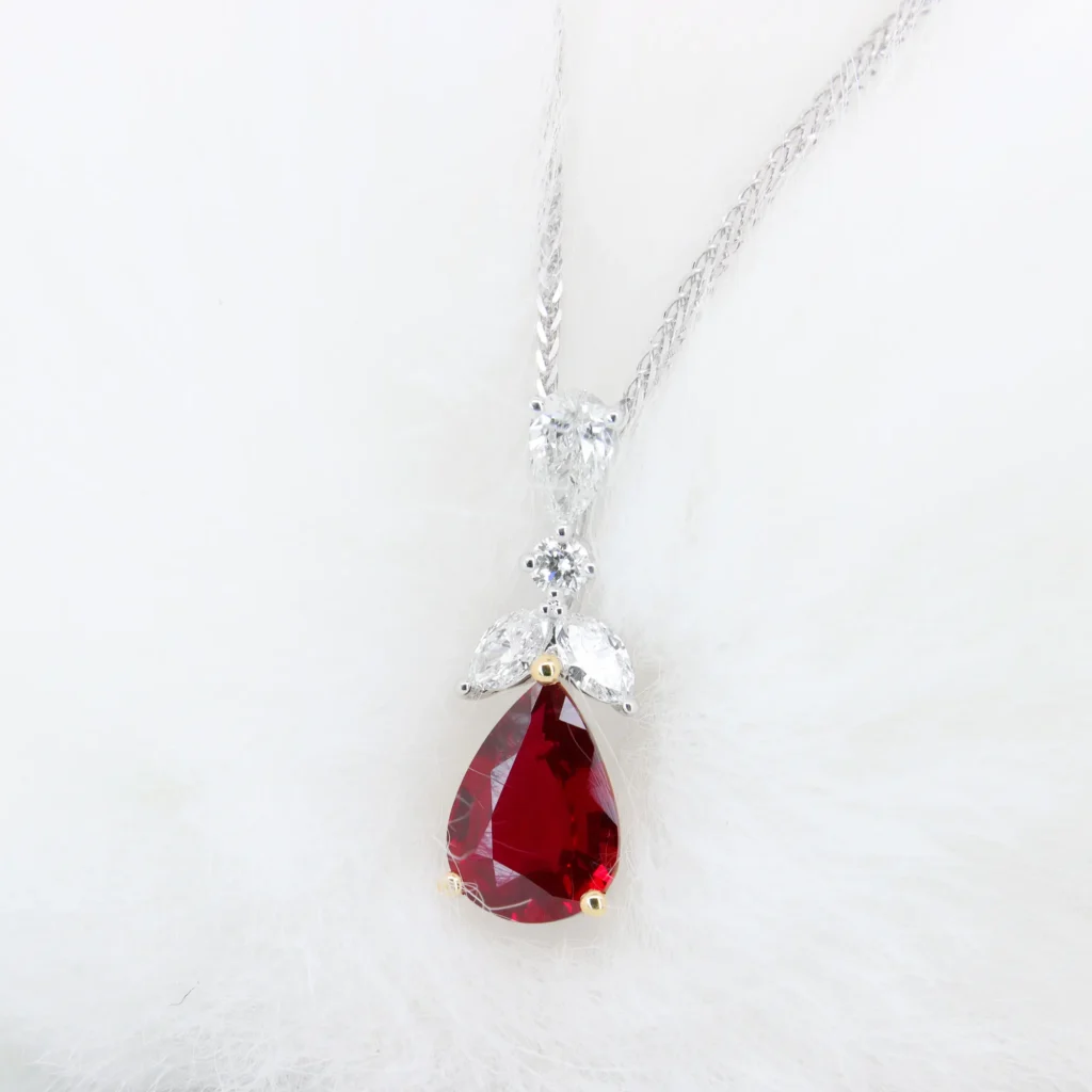 1.12ct unheated pigeon blood ruby pear pendant with yellow gold claws and a diamond bail in white gold