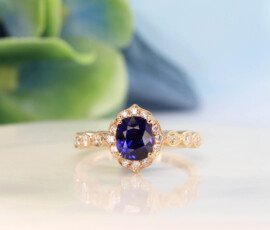 Art deco Proposal Ring with colour change sapphire, surrounded with diamonds to impart a floral and feminine look to this design. This design exudes an overall vintage art deco look with its mil-grain design | Local Singapore Private Jeweller in customised proposal ring.