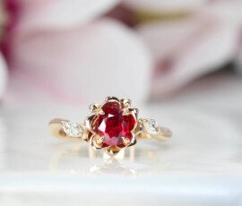 Customised Engagement ring ruby features an unheat vivid red ruby rare gemstone. With a liking for flora design, we customised this engagement ring with marquise diamond with flora leaves and petals in rose gold surrounding the ruby gemstone | Local Singapore Jeweller in engagement ring and wedding jewellery.