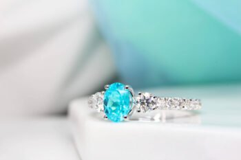 Brazilian Paraiba Tourmaline is a fascinating rare gem that exhibits a sensational colour shade. The unique colour shade of a Brazil Paraiba make it of the rarest gem on world which is priced much more than a diamond. This customised engagement ring is customised with side round diamonds and a pave of 3/4 diamonds.