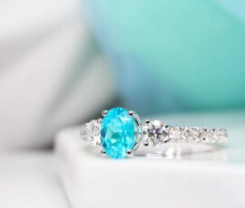 Brazilian Paraiba Tourmaline is a fascinating rare gem that exhibits a sensational colour shade. The unique colour shade of a Brazil Paraiba make it of the rarest gem on world which is priced much more than a diamond. This customised engagement ring is customised with side round diamonds and a pave of 3/4 diamonds.