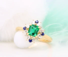 Emerald Proposal Ring with Halo Diamond Ring with diamond and blue sapphire at GIOIA Fine Jewellery
