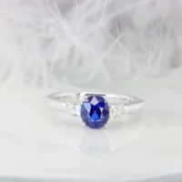 1.29ct unheated royal blue sapphire trilogy ring, oval cut, with pear-shape side diamonds in platinum, GRS certified